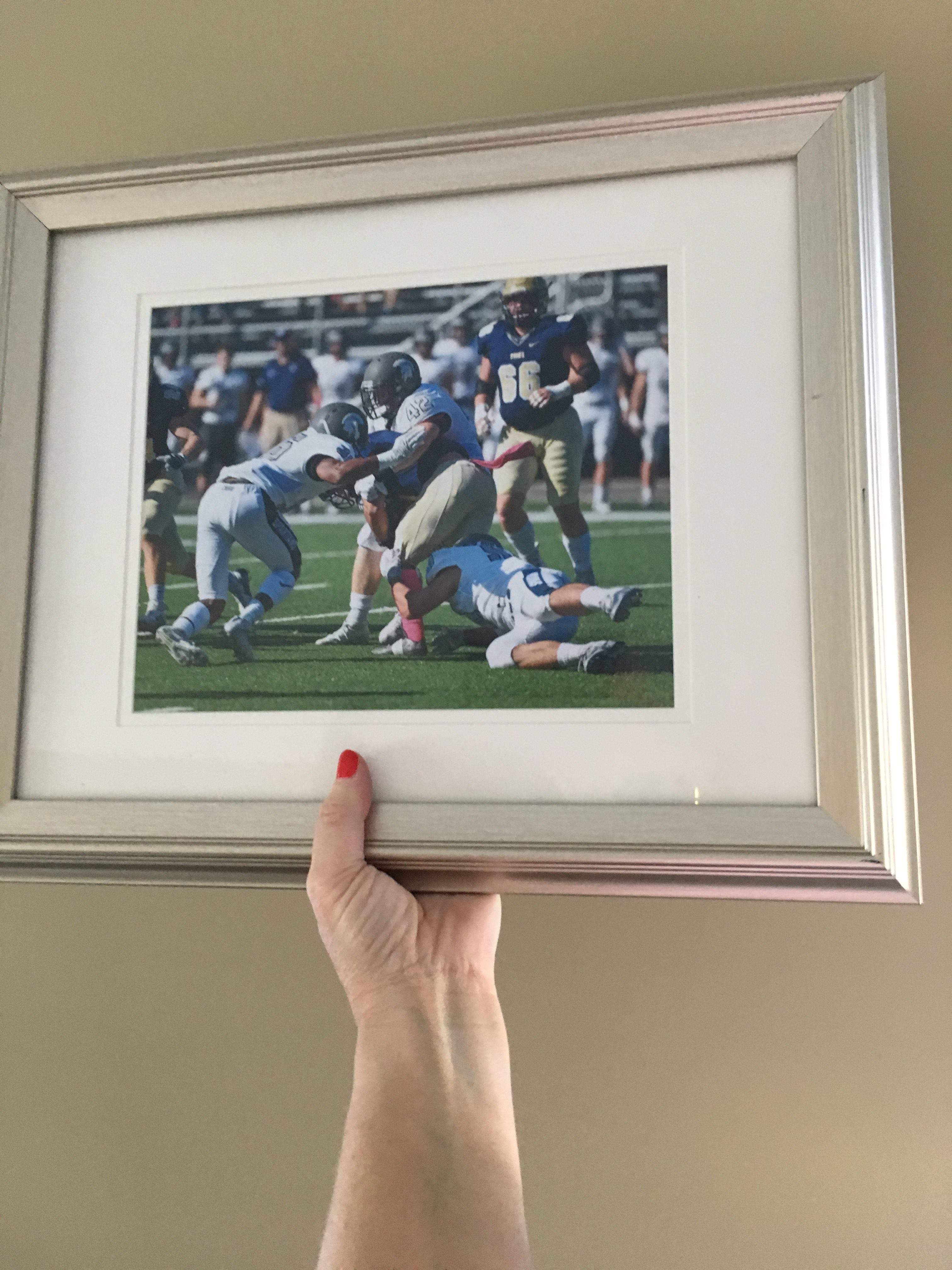 Framed picture of son making a football tackle