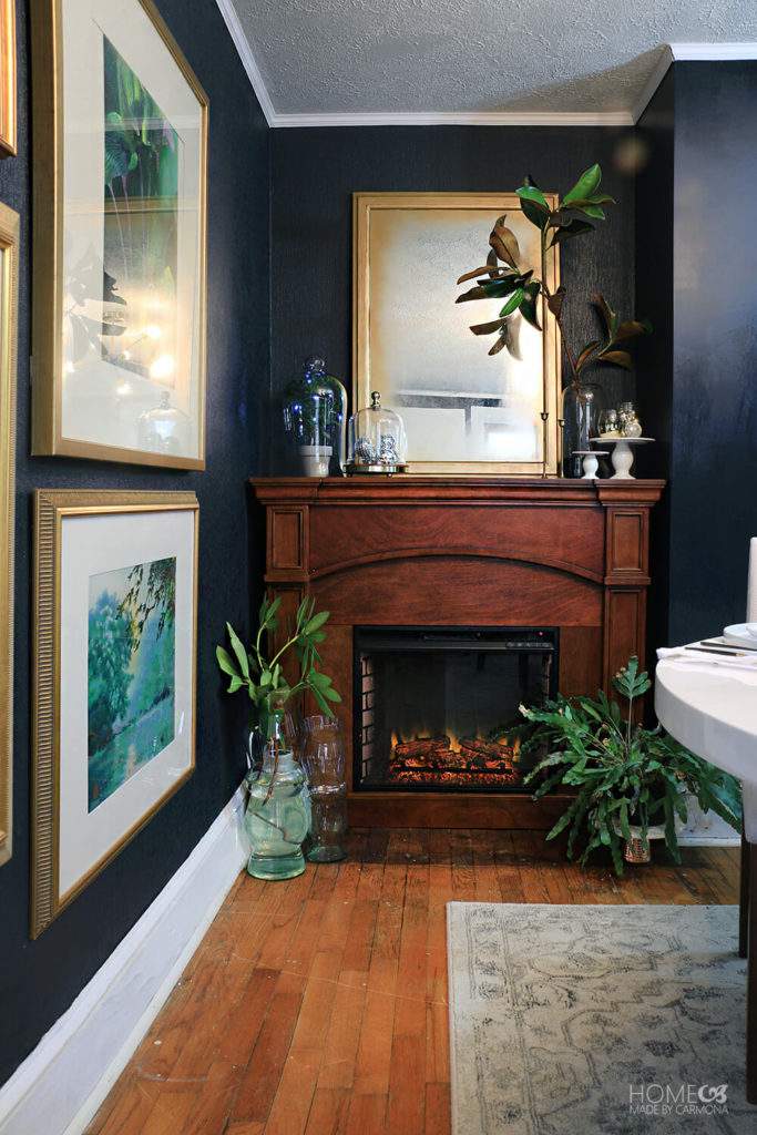 stained wood mantel and navy blue walls