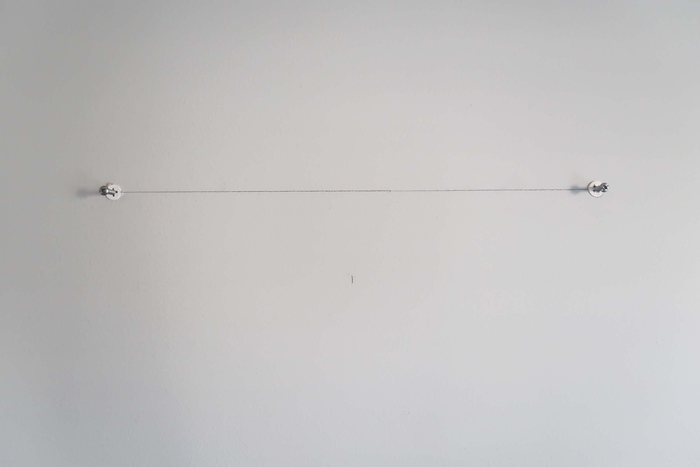 screws-in-anchors-on-wall-hang-artwork-mirror-keyholes