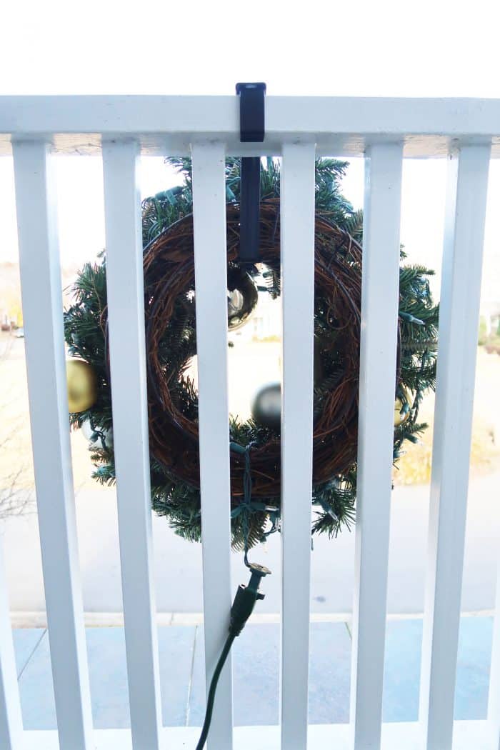 Looking through railing to see hanging wreath