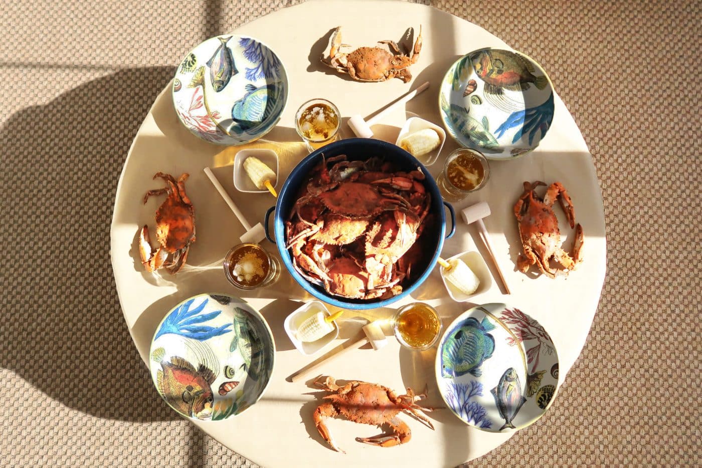 round table with maryland crab feast, blue pot, fish bowls, mallets, blue stock pot
