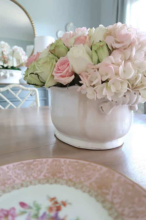 pink and green roses with pink hydrangeas in ceramic planter