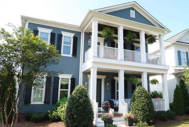 blue house with double front porches charleston style house with southern charm