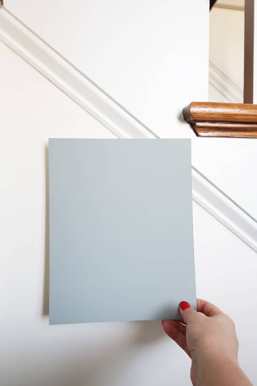 hold-paint-sample-up-against-different-colors-of-white-for-comparison