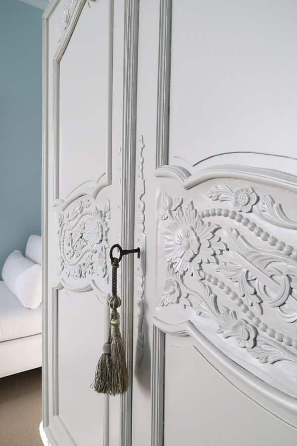 close-up-carved-detail-french-armoire-painted-valspar-light-raffia-cabinet-enamel