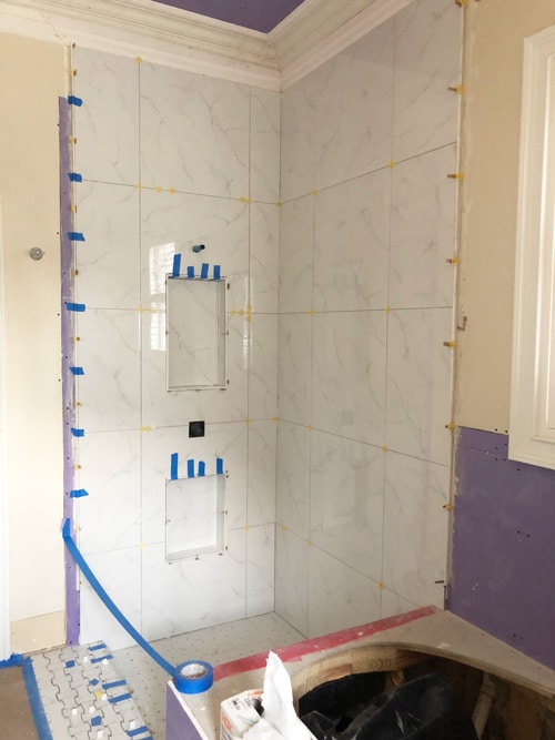 large-format-marble-look-porcelain-tile-installed-in-master-bathroom-shower-remodel
