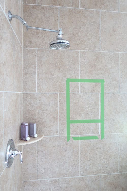 mapping-out-bathroom-shower-niche-with-painters-tape