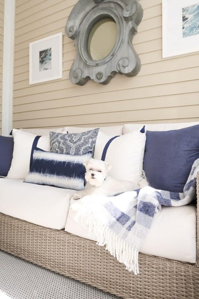 mixing-white-and-navy-pillows-on-outdoor-sofa-maltese-blue-and-white-throw-min