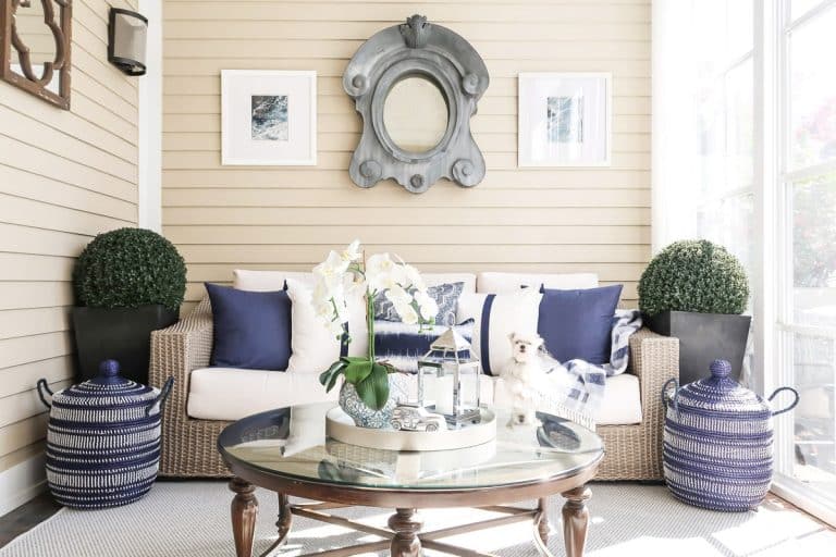 white-navy-driftwood-screened-porch-round-coffee-table-maltese-sofa-min