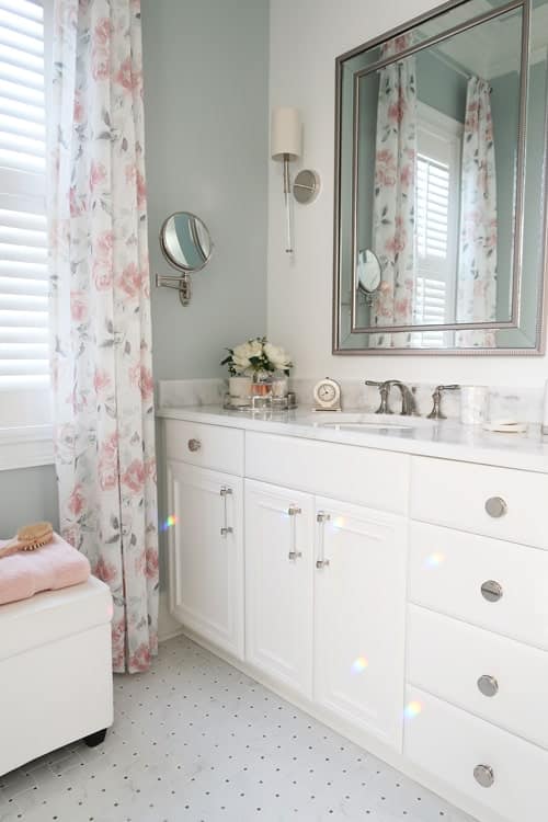 faux-flowers-on-tray-Rainbows-reflecting-on-white-bathroom-cabinets