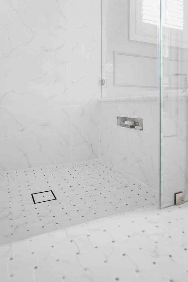 mosaic-tile-shower-floor-zero-entry-tiled-drain-shaving-nook-marble-look-porcelain-wall-tile-porch-daydreamer