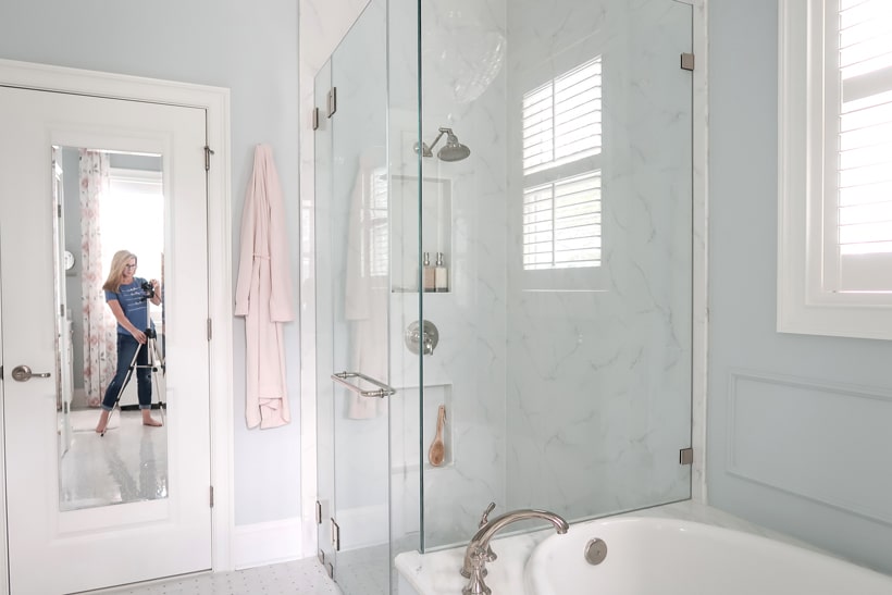 porch-daydreamer-in-mirror-shooting-master-bathroom-shower-and-tub-porcelain-slab-marble-look-tile