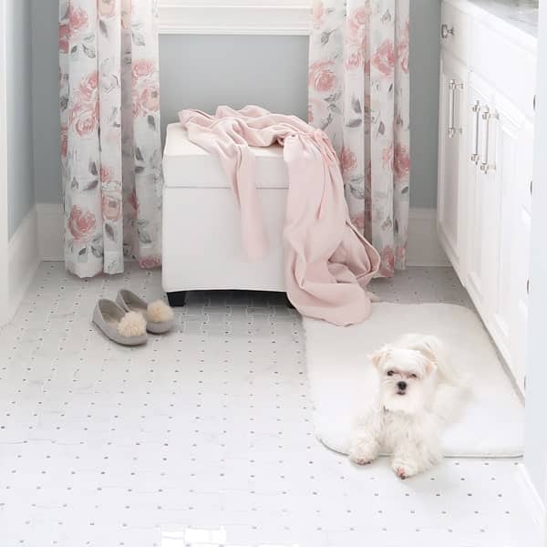 white-maltese-dog-laying-on-soft-white-mohawk-home-bath-rug-min
