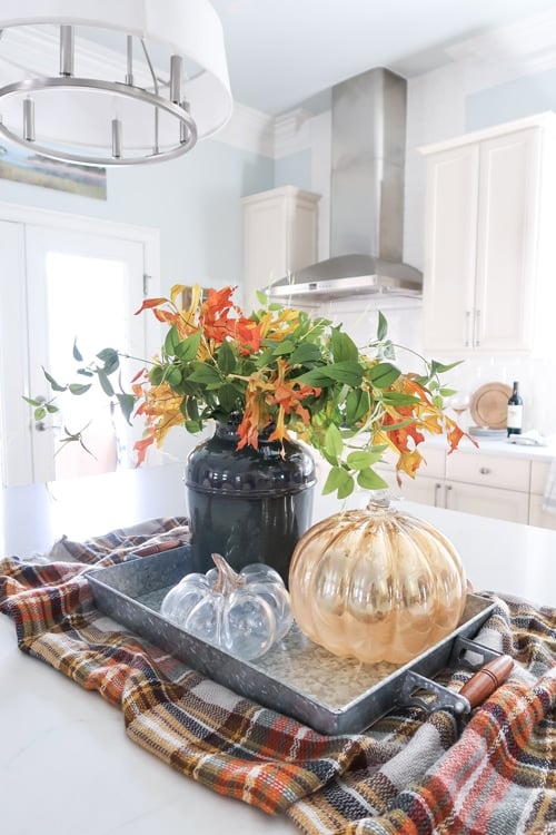 affordable-fall-decorating-kitchen-island-scarf-under-tray-with-glass-pumpkins-and-fall-leaf-arrangements
