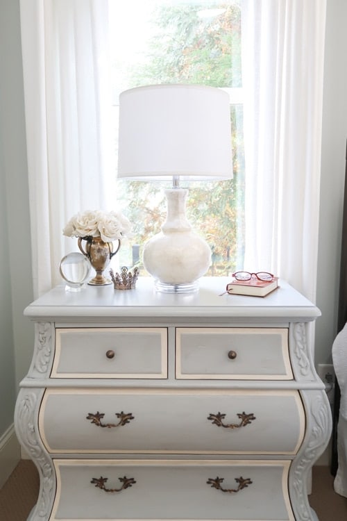 white-drapes-framing-blue-painted-nightstand