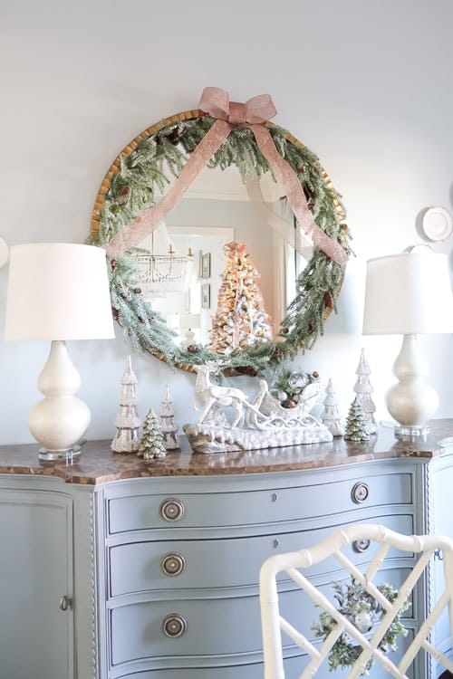 close-up-of-blue-credenza-and-garland-trimmed-mirror