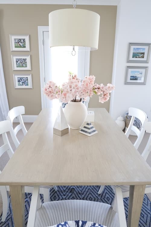 Driftwood-Gray-Faux-Finish-on-table-surrounded-by-white-chairs