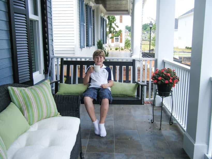 Michael-sipping-hot-chocolate-on-the-front-porch-black-swing-and-bench
