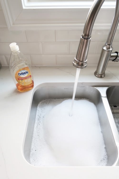Sink-filled-with-soapy-water-to-wash-hardware-wtih-dawn-dish-detergent