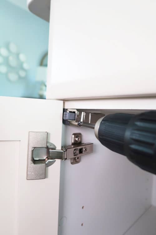 tighten-screw-with-power-dril-into-side-of-cabinet
