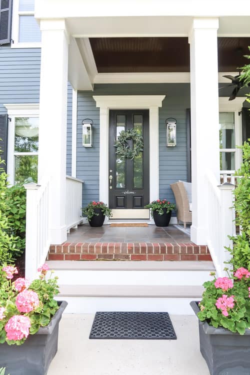 dark-blue-siding-black-front-door-pink-flowers-front-entry-curb-appeal