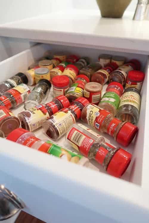 Unorganized-spice-bottles-in-drawer-angle