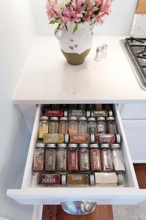 looking-down-glass-spice-jars-in-drawer