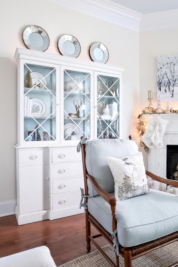 blue-chair-painted-blue-and-white-china-cabinet-with-christmas-mantel