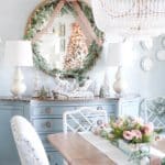 dining-room-table-decorated-with-pink-flowers-and-garland-round-mirrow-trimmed-in-garland