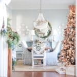 view-of-dining-room-with-decorated-tree-and-garland-on-the-stairs