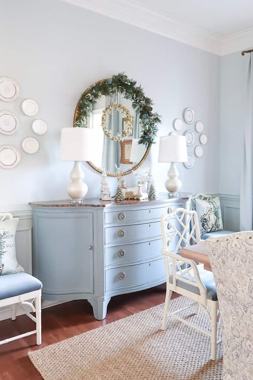 dining-room-mirror-decorated-garland-round-blue-credenza