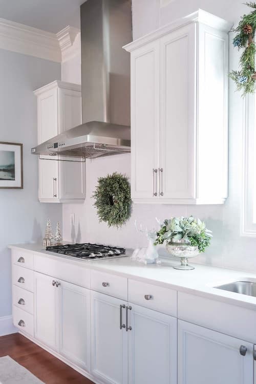 christmas-wreath-above-stove-kitchen-white-cabinets