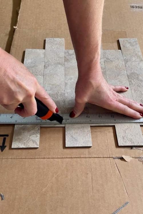 score-peel-stick-tile-straight-edge-utility-knife-cardboard-box