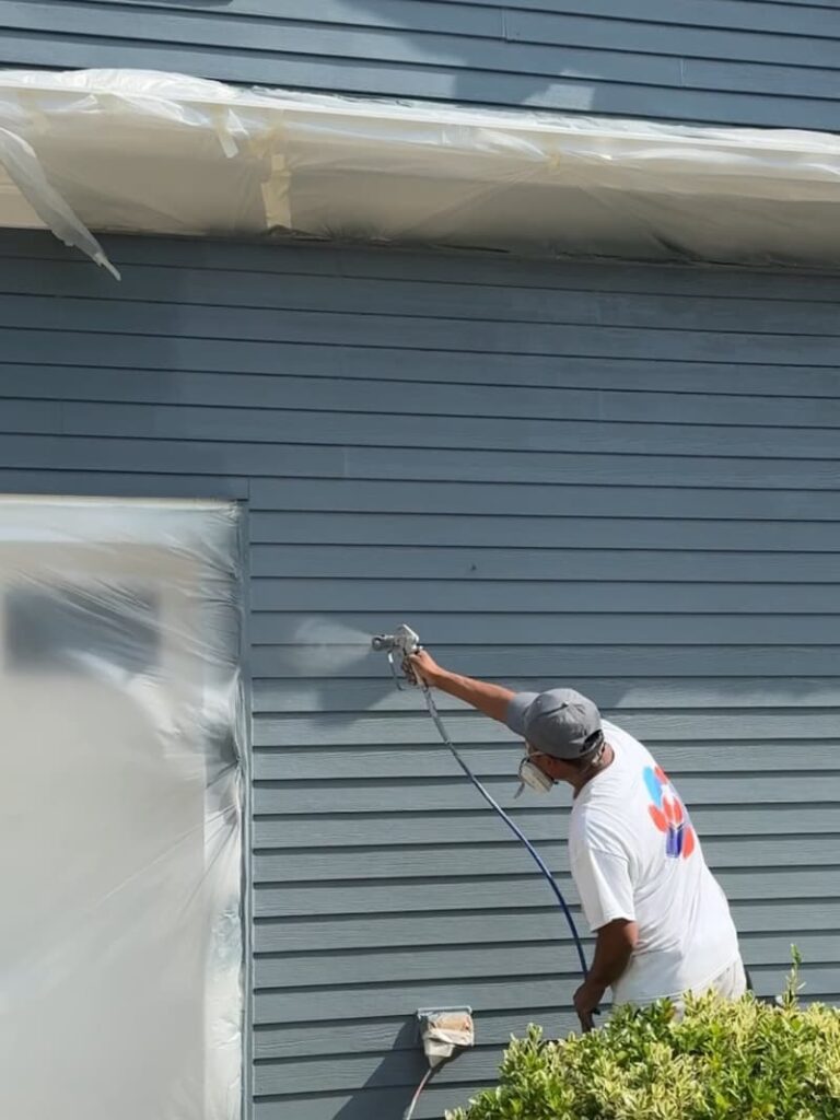 spraying-exterior-paint-siding